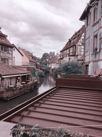 Railroad tracks amidst buildings in city against sky