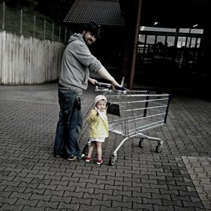 Full length of young woman sitting on bench