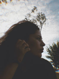 Portrait of woman against tree