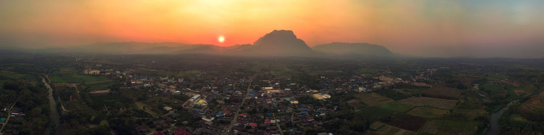 Aerial view of townscape against sky during sunset