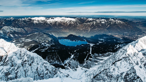 Aerial view of snowcapped mountains against sky