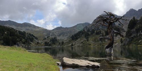 Scenic view of lake and mountains against sky