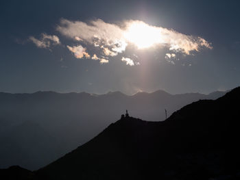 Scenic view of silhouette mountains against sky