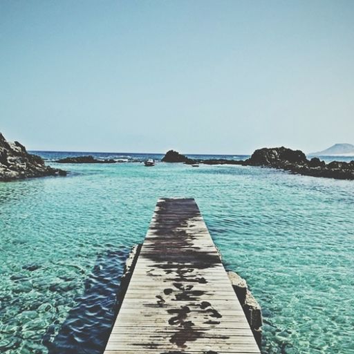 water, clear sky, blue, sea, copy space, the way forward, tranquil scene, tranquility, pier, scenics, horizon over water, beauty in nature, nature, diminishing perspective, jetty, railing, idyllic, day, rippled, long