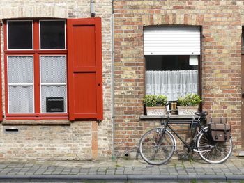 Bicycle against brick wall of building