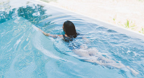 High angle view of woman swimming in pool