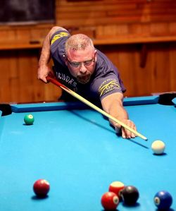 Close-up of man playing pool