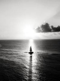 Sailboat sailing on sea against sky