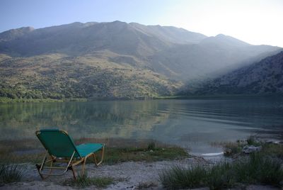 Scenic view of lake by mountains against sky