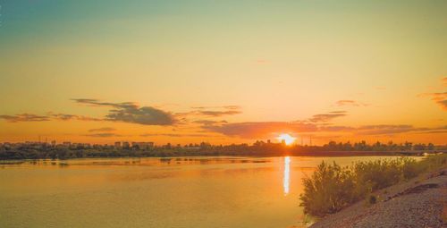 Scenic view of lake against sky during sunset