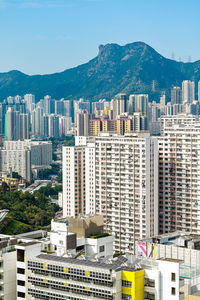 Buildings in city against clear sky