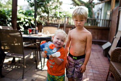 Portrait of shirtless boy standing outdoors