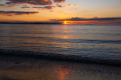 Scenic view of sea against romantic sky at sunset