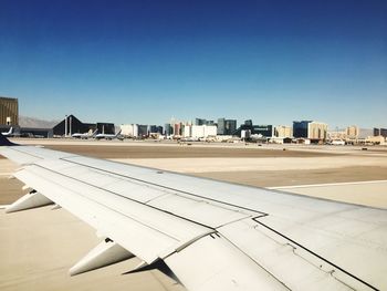 Airplane on runway against clear sky