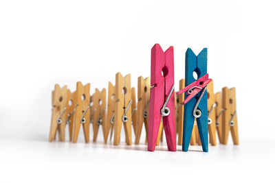 Close-up of multi colored clothespins against white background