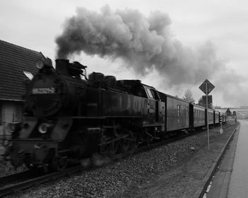 Train on railroad track against sky