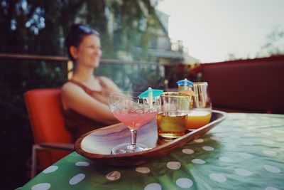 Woman sitting on table at restaurant 