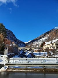 Scenic view of snowcapped mountains against blue sky