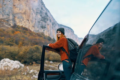 Portrait of happy young woman looking away on mountain