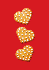 Close-up of heart shape against red background