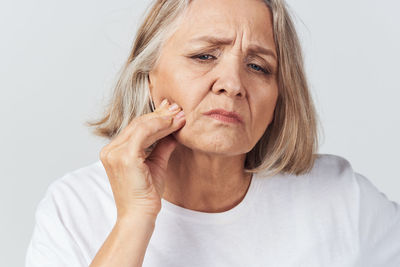 Portrait of woman against white background