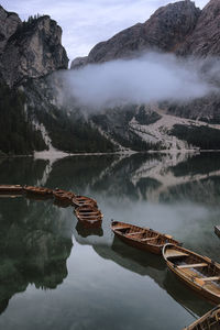 Scenic view of lake by mountains against sky