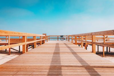 Empty wooden table against clear blue sky