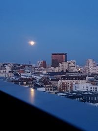 Buildings against blue sky at night