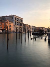 Reflection of buildings in city at sunset