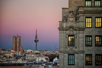 Buildings in city at sunset