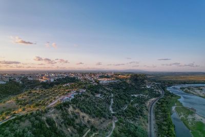 Aerial view of cityscape against sky during sunset