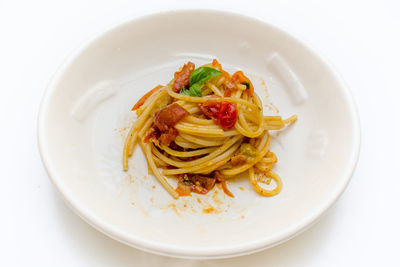 High angle view of spaghetti in plate against white background