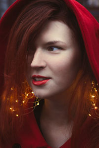 Close up elegant woman with fairy lights and hood portrait picture