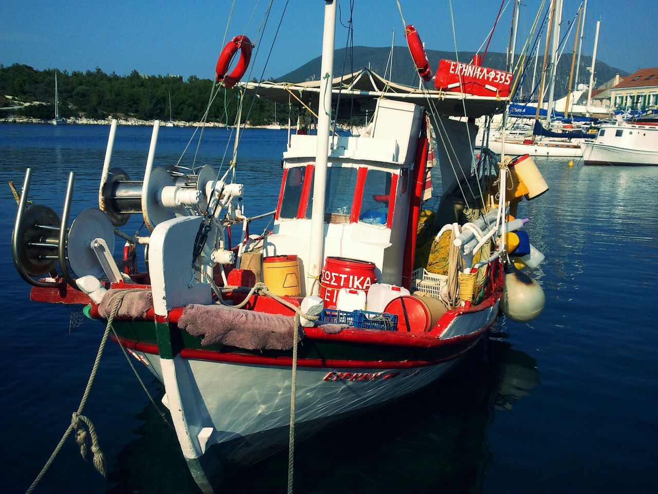 nautical vessel, water, moored, boat, transportation, rope, mode of transport, sea, harbor, blue, sailboat, waterfront, river, day, hanging, outdoors, buoy, no people, sky, lake