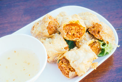 Close-up of spring roll in plate on table