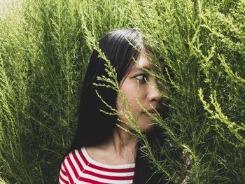 Portrait of young woman on field
