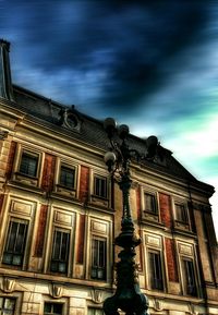 Low angle view of building against cloudy sky