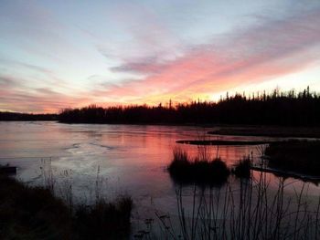 Scenic view of lake against sky during sunset