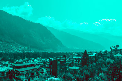 Aerial view of townscape against sky during winter