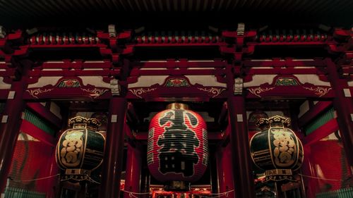 Low angle view of illuminated lanterns hanging in building