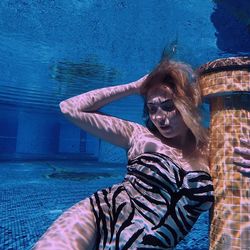 Portrait of young woman in water