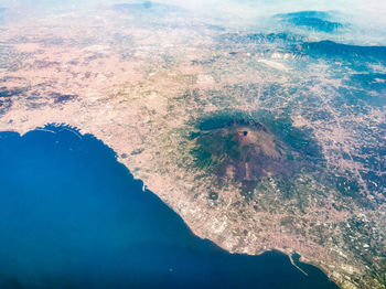 High angle view of land and sea against sky