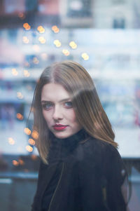 Close-up portrait of young beautiful woman in city