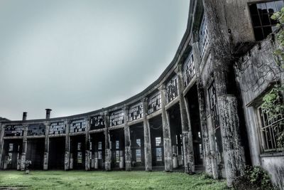 Low angle view of abandoned building against sky