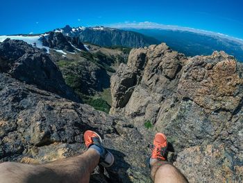 Low section of person on rock in mountains