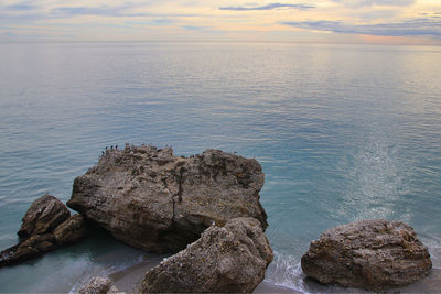 Rocks in sea against sky