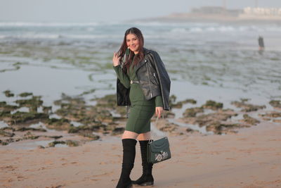 Full length portrait of woman standing on beach