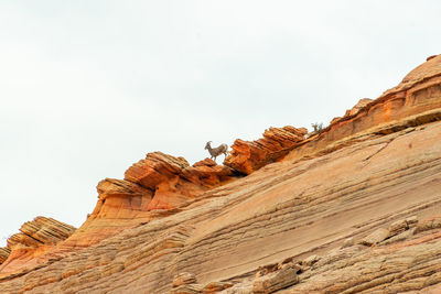 Low angle view of rock formations against sky