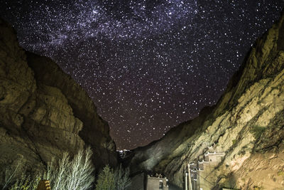 Low angle view of mountain against sky at night