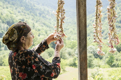 Senior woman holding garlic bulbs